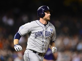 San Diego Padres third baseman Chase Headley (7) runs after hitting a RBI triple in the seventh inning against the Colorado Rockies at Coors Field on July 7, 2014 in Denver, CO, USA (Ron Chenoy/USA TODAY Sports)