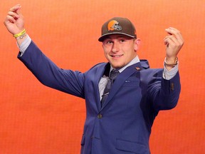 Johnny Manziel gestures as he walks across the stage after being selected by the Browns at the NFL draft in New York on May 8, 2014. (Brad Penner/USA TODAY Sports)