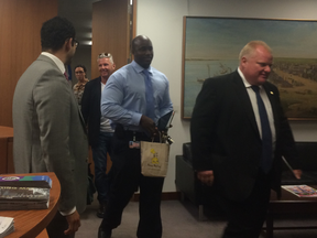 Mayor Rob Ford leaves his office with his driver Jerry Agyemang and former sobriety coach Bob Marier Tuesday, July 22, 2014. (Don Peat/Toronto Sun)