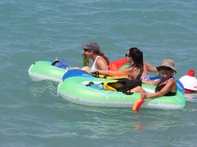 A trio of women take off from the Canadian side of the St. Clair River during the annual Port Huron Float Down Sunday, Aug. 18, 2013. Both Canadian Coast Guard and OPP vessels were patrolling the area near the Blue Water Bridge, keeping recreational and commercial boats away from the thousands of participants navigating inflatable boats and tubes. BARBARA SIMPSON / THE OBSERVER / QMI AGENCY