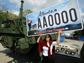 Toronto based photographer and artist Silvia Pecota holds a large version of the Support Our Troops licence plate, which gives Albertans a new way to show their respect and appreciation for Canada’s brave service men and women. TOM BRAID/EDMONTON SUN/QMI AGENCY