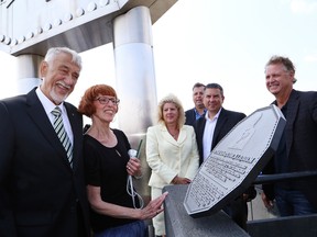 JOHN LAPPA/THE SUDBURY STAR
Big Nickel creator Ted Szilva, left, and his wife, Betty, examine a plaque that was created in his honour and unveiled during the Big Nickel celebration at Dynamic Earth in Sudbury, ON. on Tuesday, July 22, 2014. The Big Nickel turned 50.