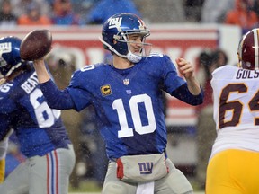 New York Giants quarterback Eli Manning (10) throws a pass against the Washington Redskins in the first half during the game at MetLife Stadium on Dec 29, 2013 in East Rutherford, NJ, USA. (Robert Deutsch/USA TODAY Sports)