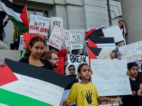 More than 200 people crowded around City Hall Wednesday evening in a show of protest against Israeli attacks on civilians in Gaza. (Alex Pickering/For The Whig-Standard)