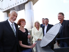 JOHN LAPPA/THE SUDBURY STAR/QMI AGENCYBig Nickel creator Ted Szilva, left, and his wife, Betty, examine a plaque that was created in his honour and unveiled during the Big Nickel celebration at Dynamic Earth in Sudbury, ON. on Tuesday, July 22, 2014. The Big Nickel turned 50.
