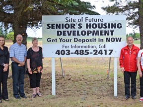 Jenna Dulewich VULCAN ADVOCATE Left to Right - Marketing consultant for the project Sarah Vaudry, Director of Community Development for the town Jeff Johnstone, Councillor Lorna Armstrong, Councillor John Seamen, volunteer Hannah McDonald and volunteer Jean Jordan.  The new sign that has been put up for the proposed future seniors facility in Vulcan, next to the hospital.