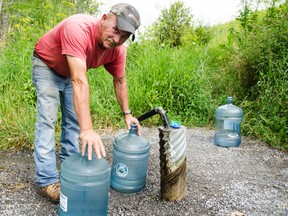 Dale Flemming has used Stirling's spring on a weekly basis for the past ten years. Flemming said he will be displeased if the spring closes because this will mean he must pay an unfair price for water. Belleville On. Wednesday, July 23,  2014.    
Lacy Gillott/The Intelligencer