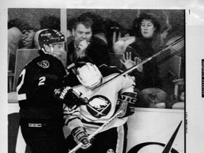 Ottawa Senators' Jim Paek checks Buffalo Sabres' Donald Audette during a 1995 game at the Buffalo Memorial Auditorium. (QMI Agency)