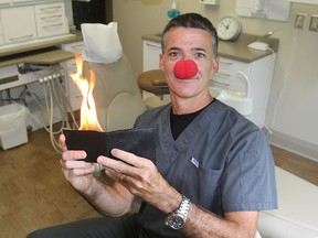 Dentist Dr. Dave Gouett uses magic tricks to entertain the children who come to his dental practice, reducing their apprehension and fear. (Michael Lea/The Whig-Standard)
