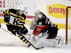 Iroquois Falls native Ryan Kujawinski, shown making a move on Niagara Ice Dogs goalie Christopher Festarini during OHL game at the K-Rock Centre in Kingston, will attend training camp with the New Jersey Devils this fall, but he will likely return to Kingston for his fourth year with the Frontenacs. (Ian MacAlpine/Whig-Standard file photo)