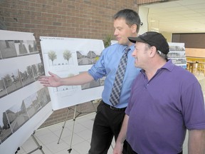 Municipal planner Ryan Jacques, left, and Paul Shettell, chair of the Historic Downtown Chatham BIA, discuss conceptual streetscape designs during a public meeting at the Chatham-Kent Civic Centre on Wednesday. TREVOR TERFLOTH/ THE CHATHAM DAILY NEWS/ QMI AGENCY