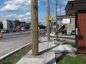 A hydro pole in the middle of the sidewalk on Boulevard Henri-Bourassa in east Montreal, July 22, 2014. (SARAH BELISLE/QMI Agency)