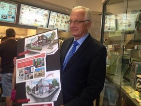 Hamilton Mayor Bob Bratina holds a picture of the planned renovation of the original Tim Hortons store. (MATT INGRAM/Toronto Sun)