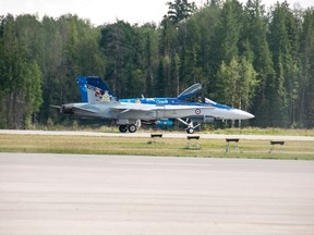 A CF-18 touches down in Whitecourt, ALta., after an emergency landing after being struck by lightning, Thursday, July 24, 2014. Bryan Passifiume QMI Agency