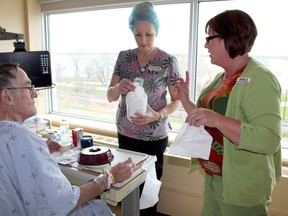 Sheila Chartrand, right, infection control practitioner at QHC, works with a patient at Belleville General Hospital on hand hygiene before eating. Dietary staff are working with patients to ensure their hands are sanitized before they eat, which has resulted in a reduction of certain infections. 
Submitted photo.