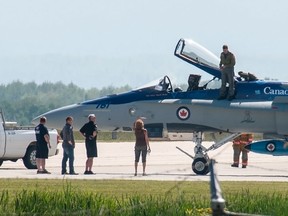 Captain Adam Runge climbs out of his plane after landing in Whitecourt. The CF-18, en route to perform in the Whitecourt Air Show, was struck by lightning south of  town. Bryan Passifiume photo | Whitecourt star