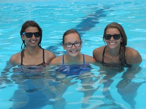 Abby Hemming, 17, a lifeguard, Grace Poland, 14, a volunteer and Tori Low, 20, the head lifeguard at the Woodcrest Community Pool, won?t have to worry anymore about unwelcome water when it rains, thanks to the generous support of various London businesses and groups. (JENNIFER BIEMAN, The London Free Press)