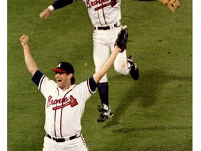 Braves third baseman Chipper Jones runs toward reliever Mark Wohlers after Atlanta defeated Cleveland to claim the 1995 World Series. Despite reaching the post-season 14 consecutive times from 1991 to 2005, the Braves won the title just once. (FILE PHOTO)