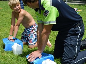 Chase Beres (left) practices the CPR lesson he learned Thursday, July 24 with primary care paramedic Sean VanAlphen at the Lake Lisgar Water Park in Tillsonburg. (JEFF DERTINGER / QMI Agency)