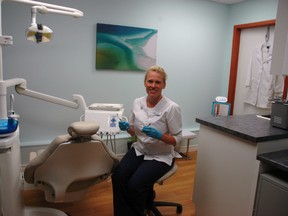Sarah Foshay sits next to a patient's chair in Smart Dental Hygiene in Aylmer, which she says is the first independent dental hygiene clinic in Elgin county. (Ben Forrest, Times-Journal)