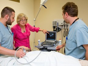 Dr. Pat Morley-Forster, middle, talks with Dr. Mike Pariser, left, and Dr. Amjad Bader as they perform an ultrasound on a patient's neck at St. Joseph's Pain Management Clinic in London, Ontario on Thursday July 24, 2014. (CRAIG GLOVER, The London Free Press)
