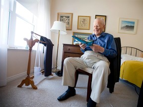 Don Edy holds a model of a Hawker Hurricane, like the one he flew in North Africa during the Second World War, as he sits in his room at Richmond Woods Retirement Residence in London, surrounded by artwork by his late father. (CRAIG GLOVER, The London Free Press)