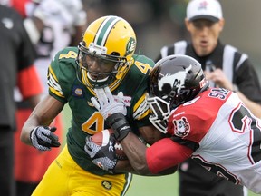 Eskimos' Adarius Bowman is force out of bounds by Stampeders' Brandon Smith Thursday at Commonwealth Stadium. (Reuters)