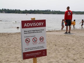 JOHN LAPPA/THE SUDBURY STAR
An advisory warning swimmers of blue-green algal blooms in Ramsey Lake is posted on a sign at the main beach at Bell Park on Thursday.