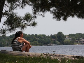JOHN LAPPA/THE SUDBURY STAR
Adrienne Maisonoquaishkang enjoys the scenery while relaxing at Bell Park in this file photo.