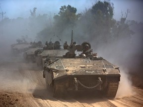 Israeli APCs drive near the Israeli border with Gaza as the come out of the Gaza Strip July 25, 2014. (REUTERS/Nir Elias)