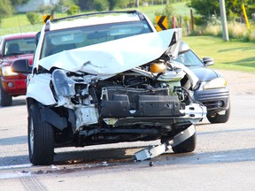 Cars swerve around an SUV with severe frontal damage on Hickory Drive after a collision with another SUV at the intersection of Egremont Drive July 25 at approximately 8:30 a.m. ELENA MAYSTRUK/ AGE DISPATCH/ QMI AGENCY