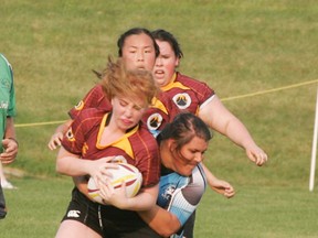 A  Sharks’ player (blue) attempts a tackle amongst a swarm of opposition players in their latest outing. - Gord Montgomery, Reporter/Examiner