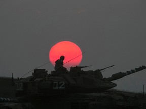 An Israeli tank manoeuvres outside the northern Gaza Strip July 21, 2014. (REUTERS/Baz Ratner)