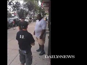 Eric Garner, right, is pictured in a video clip posted on the New York Daily News website. The image shows Garner just before he was tackled to the ground by New York police officers when they attempted to take him into custody. (nydailynews.com screengrab)