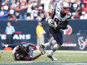 New England Patriots tight end Rob Gronkowski (87) runs after a reception against Houston Texans safety D.J. Swearinger (36) in the fourth quarter at Reliant Stadium on Dec 1, 2013 in Houston, TX, USA. (Matthew Emmons/USA TODAY Sports)