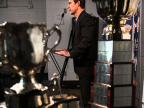 Ryan Marsh, shown between the Memorial Cup (left) and the Ed Chynoweth WHL championship trophy,is announced as the new Asst. Coach for the Edmonton Oil Kings during a press conference at Rexall Place in Edmonton, Alberta on July 25, 2014.  Perry Mah/Edmonton Sun/QMI Agency