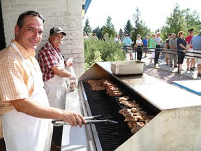 JOHN LAPPA/THE SUDBURY STAR/QMI AGENCY
Paul Vlahos, left, and George Alexakis prepare food  for a large crowd for dinner at the annual Greek Festival of Sudbury at St. Nicholas Greek Orthodox Church on Ester Road in Sudbury, ON. on Friday, July, 25, 2014. The festival includes music, dance performances, a refreshment tent and activities for children. The festival runs until Sunday.