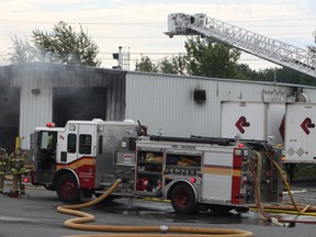 Firefighters say more than $1 million in damage was done to a storage shed and two vehicles which burned on Colonnade Rd. Saturday morning, July 26, 2014. The fire is under investigation by Ottawa police. 
Doug Hempstead/Ottawa Sun​/QMI Agency