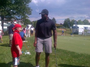 Montreal Canadiens defenceman PK Subban gives a kid some golf tips at the RBC Canadian Open. (Steve Buffery/QMI Agency)