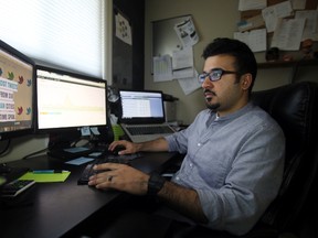 University of Alberta PhD candidate Irfan Chaudhry looks over findings from his 3-month Twitter Racism research project from his home in Edmonton, AB on July 24, 2014. In 2013, Chaudhry examined 900 tweets containing negative racial remarks from accounts in six Canadian cities. He will present his findings at the 2014 Social Media and Society International Conference in Toronto, Ont, on Sept. 27-28. TREVOR ROBB/Edmonton Sun/QMI Agency