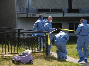 Calgary City Police Crime Scene Investigators enter the scene of the suspicious death of a woman inside a southeast Calgary home on Saturday, July 26, 2014. Police have since declared the woman's death the city's 21st homicide of the year.
Stuart Dryden/Calgary Sun/QMI Agency