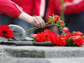 A person lays roses on the Tomb on the Unknown Soldier during the Vimy Ridge commemoration at the National War Memorial in Ottawa Friday April 9, 2010.  Canada's last living World War One veteran John Babcock died at 109 years old on February 18, 2010.
(ANDRE FORGET/QMI AGENCY)