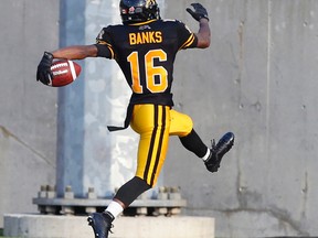 Hamiltons' #16 Brandon Banks high steps for the first touchdown.  Ottawa Redblacks vs Hamilton Tiger-Catsduring CFL action in Hamilton  Ont. on Saturday July 26, 2014. Craig Robertson/Toronto Sun/QMI Agency