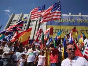 Foreign citizens working and living in Ukraine wave the flags of their countries during a rally demanding justice for the victims of the downed Malaysia Airlines Flight MH17, at Independence Square in Kiev July 27, 2014.   REUTERS/Konstantin Grishin