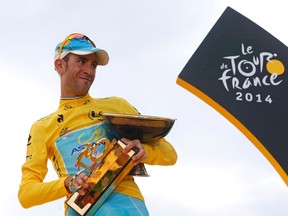 Astana team rider Vincenzo Nibali of Italy celebrates his overall victory on the podium after the 137.5 km final stage of the 2014 Tour de France in Paris, July 27, 2014.   REUTERS/Christian Hartmann