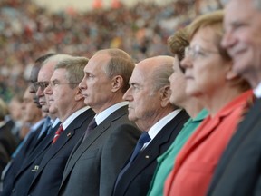 Russia's President Vladimir Putin (5R) poses before the 2014 FIFA World Cup final football match between Germany and Argentina at the Maracana Stadium in Rio de Janeiro on July 13, 2014.  (AFP PHOTO / RIA NOVOSTI POOL / ALEKSEY NIKOLSKYI)