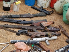 Confiscated weapons are displayed after a Nigerian military raid on a hideout of suspected Islamist Boko Haram members in Nigeria's northern city of Kano in this August 11, 2012 file photo.  To match Special Report NIGERIA-KIDNAP/MISSTEPS   REUTERS/Stringer/Files