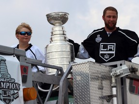 Jake Muzzin, right, holds the Stanley Cup to the thousands of Woodstonians that came out to see him Sunday July 27, 2014. Muzzin, who rode a firetruck next to his cousin Luke Woudsma, had a parade and signed autographs for three hours.

GREG COLGAN/QMI Agency/Sentinel-Review