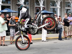 Motorcross riders from Jason Thorne FMX Stunt Riders of Peterborough perform a variety of jumps and stunts on Ontario Street in front of City Hall in Kingston on Saturday July 26 2014.  IAN MACALPINE/KINGSTON WHIG-STANDARD/QMI AGENCY