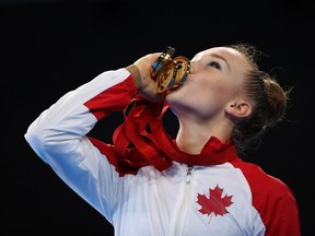 Patricia Bezzoubenko of Canada kisses her medals after competing in the rhythmic gymnastics individual apparatus finals at the 2014 Commonwealth Games in Glasgow, Scotland July 26, 2014. (REUTERS)